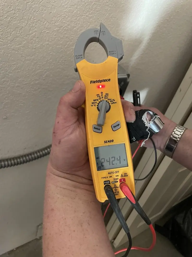 Voltage testing with clamp meter during Whole House Surge Protector in Camano